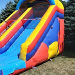 Colorful bounce house with an attached slide