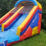 Colorful bounce house with an attached slide