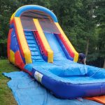 Colorful bounce house with an attached slide