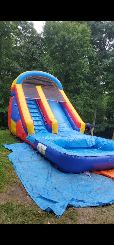Colorful bounce house with an attached slide