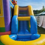 Colorful bounce house with an attached slide