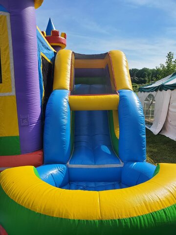 Colorful bounce house with an attached slide